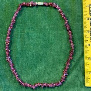 Purple glass bead necklace.